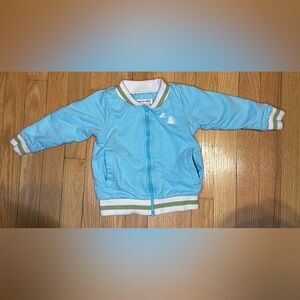 Blue Zip-Up Jacket with White and Green Accents